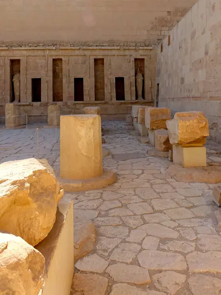 Stock image Ancient stones and architectural remnants showcase the historical beauty of Hatshepsut's Mortuary Temple in Deir el Bahri. The ruins reflect the grandeur of Egypt's past in a serene setting.