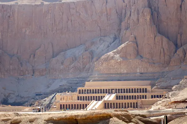 stock image The Mortuary Temple of Hatshepsut stands majestically among the mountains, showcasing ancient Egyptian architecture and historical significance.