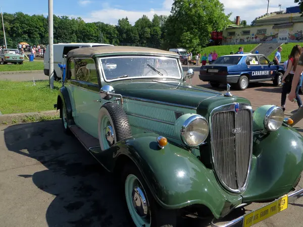 stock image Lviv, Ukraine - June 5, 2016 A vintage green AUDI Front 225 1936 convertible is showcased at an outdoor auto show, surrounded by spectators enjoying the sunny day. Classic car exhibits elegant design