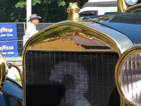 stock image Lviv, Ukraine - June 5, 2016 A classic car FORD TAXI with an ornate front grille, gleaming in sunlight, is prominently displayed at a local car show. Attendees admire the intricate details