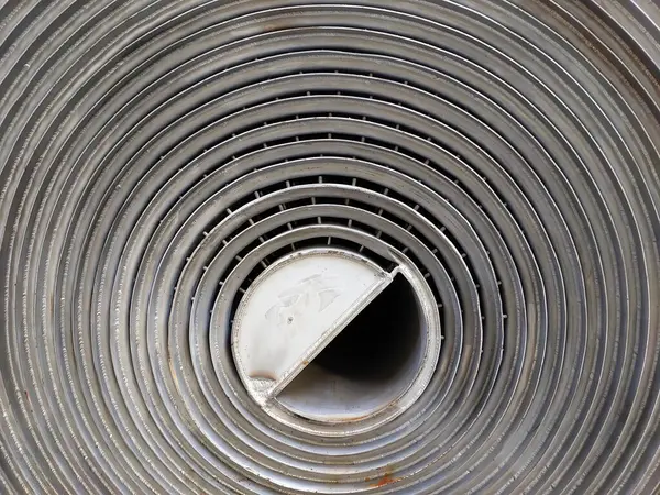 Yukarıdan paslanmaz çelikten yapılmış spiral ısı değiştirici, endüstriyel uygulamalar için enerji transferindeki detaylı yapısını ve işlevselliğini gözler önüne seriyor..