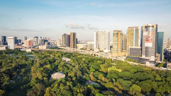 stock image Aerial view of the forest in the middle of the capital with sunset.