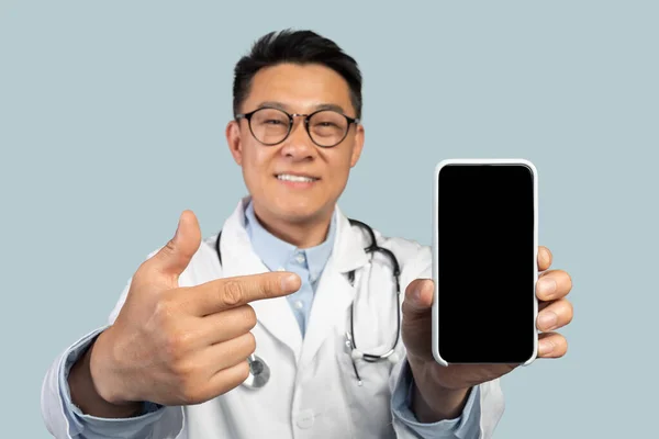 Beyaz Önlüklü Gözlüklü Orta Yaşlı Çinli Bir Terapist Akıllı Telefondan — Stok fotoğraf