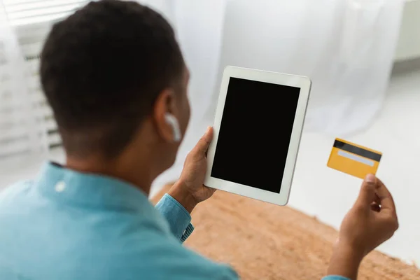 헤드폰을 아프리카 미국인 가벼운 거실에 카드가 태블릿을 불투명 사람은 집에서 — 스톡 사진