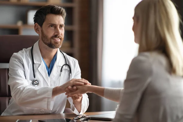 Smiling Male Doctor Holding Hand Female Patient Meeting Clinic Friendly — Stock Photo, Image