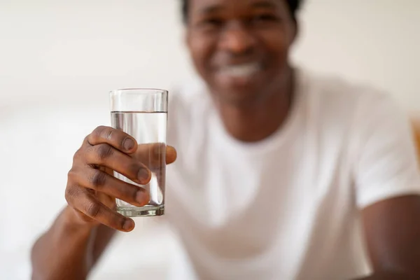 Smiling Young Black Guy Giving Glass Mineral Water Camera Happy — Stok Foto