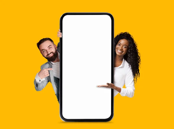 Smiling Millennial European Black Man Woman Pointing Big Smartphone Blank — Stok Foto