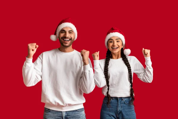 Portrait Overjoyed Arab Couple Wearing Santa Hats Celebrating Success Together — Stock Photo, Image