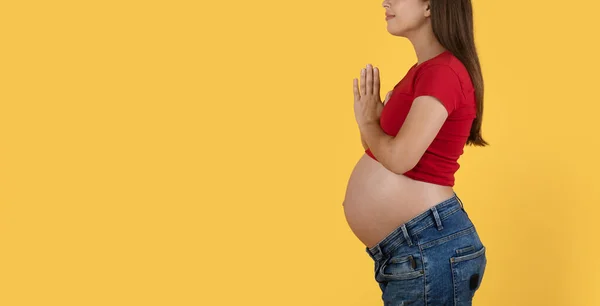 Cropped Shot Pregnant Woman Standing Clasped Hands Yellow Background Young — Stok Foto