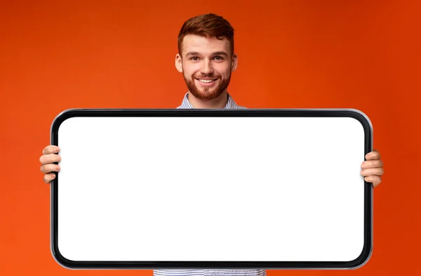 Place Cheerful Young Man Holding Big Blank Smartphone White Screen — Stock Photo, Image