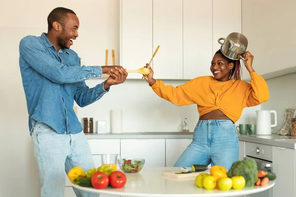 Domestic Fun Joyful Black Couple Playfully Fighting Kitchen Using Spatulas — Stock Photo, Image