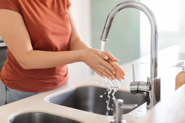 Closeup Shot Of Young Woman Washing Hands In Kitchen Sink, Unrecognizable Female Touching Running Water, Playing With Flow While Making Cleaning At Home, Lady Enjoying Domestic Chores