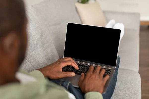 Busy Middle Aged African American Male Sofa Watch Video Typing — Stock Photo, Image