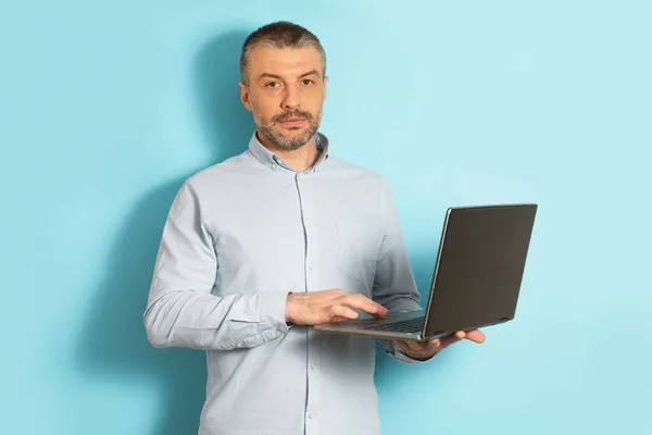 Homem Meia Idade Confiante Segurando Usando Computador Portátil Sobre Fundo — Fotografia de Stock