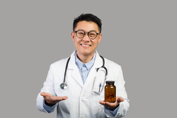 Glad Mature Asian Guy Therapist White Coat Glasses Shows Jar — Stock Photo, Image