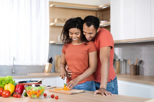 Glad Millennial Black Male Hugging Woman Red Shirt Lady Cutting — Stock Photo, Image