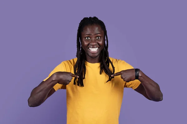 俺の事か 長いドレッドロックを持つハンサムな千年のアフリカ系アメリカ人の男は 自分自身を指して笑って 1つは 紫色の背景の上にポーズを選択されている — ストック写真