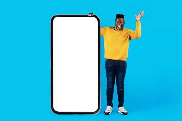 Excited Young Black Man Standing Huge Black Smartphone White Screen — Stock Photo, Image