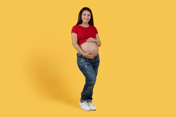 Beautiful Young Pregnant Woman Caressing Her Belly While Posing Yellow — Photo