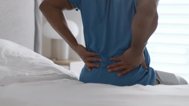 Uncomfortable Sleeping Concept Unrecognizable Black Man Pajamas Sitting Bed Home — Video