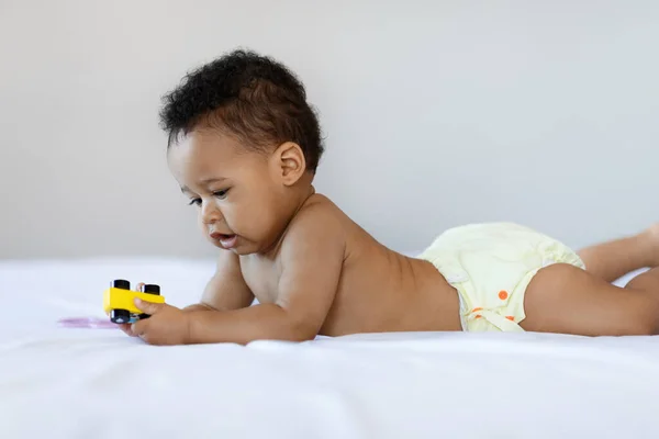 Beautiful Black Newborn Baby Playing Toy While Relaxing Bed Home —  Fotos de Stock