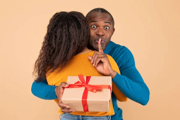 Loving Black Middle Aged Husband Hugging Wife Holding Gift Her — Stock Photo, Image