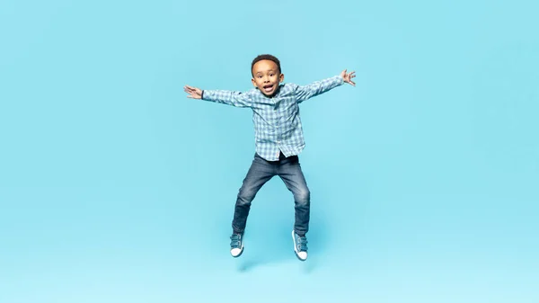 Happy Little African American Boy Posing Mid Air Jumping Spreading — Foto Stock