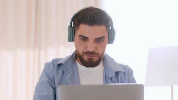 Close Portrait Young Concentrated Middle Eastern Guy Wireless Headphones Listening — Video Stock
