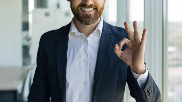 Business advertisement. Businessman in suit gesturing ok sign and smiling, male entrepreneur recommending professional services, cropped shot, closeup, panorama