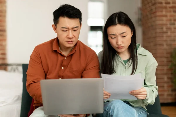 Upset Korean Spouses Checking Bills Reading Documents While Sitting Couch — Photo