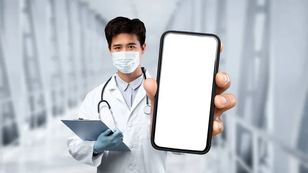 Medical App Asian Male Doctor Protective Mask Showing Blank Smartphone — Stock fotografie