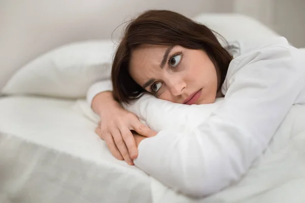Bored Sad Unhappy Attractive Brunette Young Woman Wearing White Pajamas — Zdjęcie stockowe