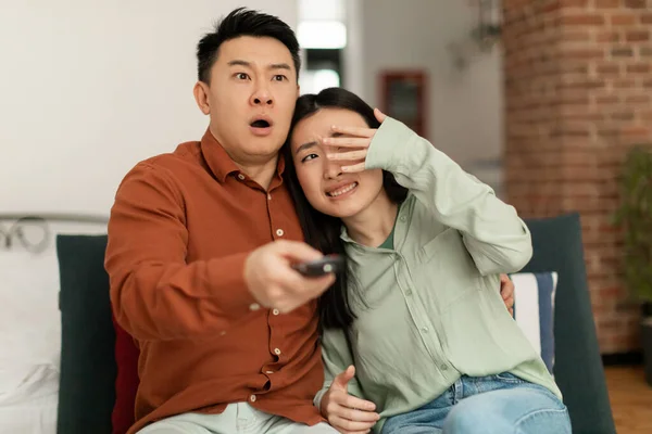 Shocked Korean Couple Watching Horror Movie Man Holding Television Remote — Photo