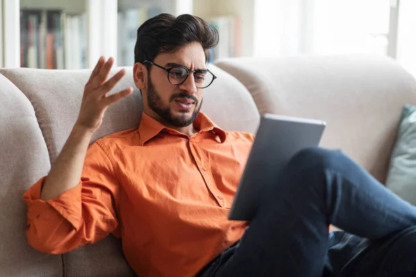 Angry Emotional Young Middle Eastern Man Wearing Eyeglasses Sitting Couch — Stockfoto