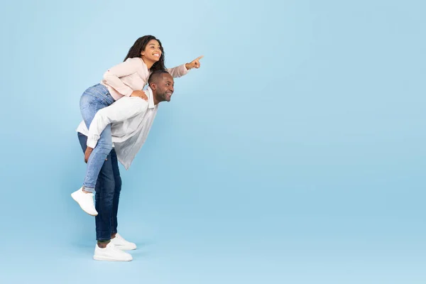 Happy Black Couple Having Fun Lady Piggybacking Man Pointing Finger — Stock Fotó