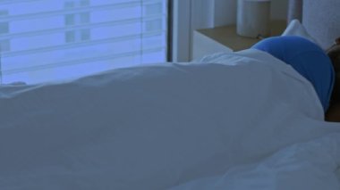 Comfortable night rest. Asleep young african american guy sleeping peacefully in his comfortable bed at home, lying with closed eyes, tracking shot, empty space