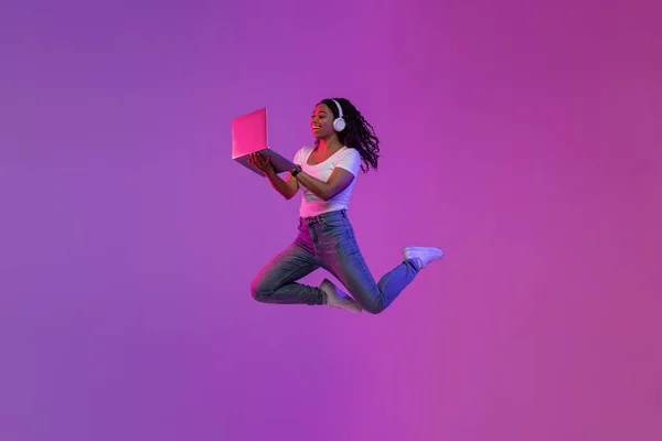 Excited Young Black Woman Using Laptop Jumping Neon Light Cheerful — Foto de Stock