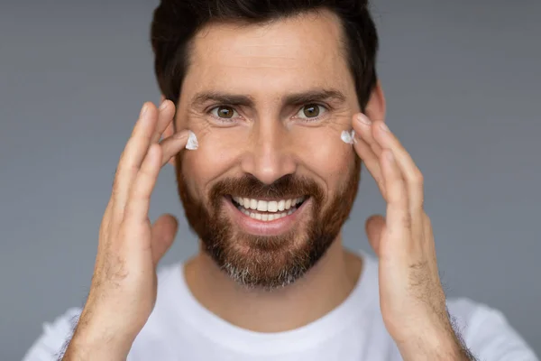 Handsome Middle Aged Man Applying Aging Cream His Face Using — Foto de Stock