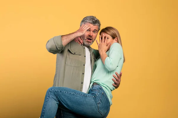 Portrait Scared Middle Aged Couple Covering Mouth Eyes Woman Jumping — Fotografia de Stock