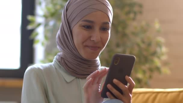 Domestic Leisure Young Happy Muslim Lady Wearing Traditional Headscarf Reading — Stockvideo