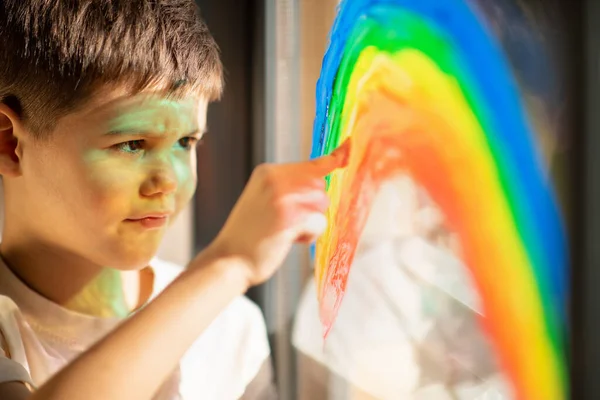 Smiling Cute European Small Kid Draws Rainbow Window Finger Paint — Stock fotografie