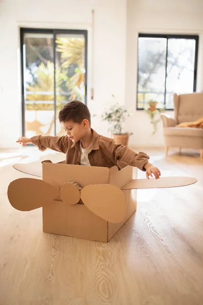 Cheerful Small European Boy Casual Plays Cardboard Box Helicopter Flies — Stock Photo, Image