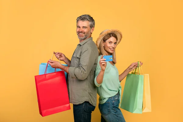 Portrait Middle Aged Caucasian Spouses Showing Credit Card Holding Colorful — Foto Stock