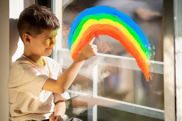 Cheerful Small European Boy Draws Rainbow Finger Window Enjoy Spare — Stockfoto