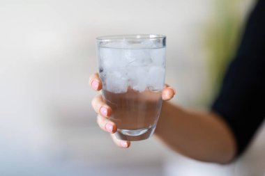 Glass Of Water With Ice Cubes In Hand Of Unrecognizable Woman, Closeup Shot Of Young Female Holding Refreshing Cold Drink, Thirsty Lady Enjoying Healthy Mineral Beverage, Cropped Image