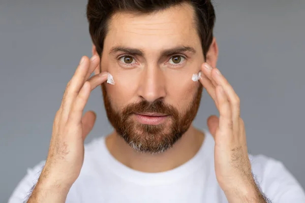 Portrait Handsome Man Applying Aging Cream His Face Using Cream — Foto de Stock