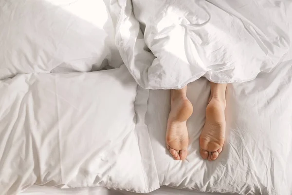 Legs Young European Female Lies White Comfortable Bed Blanket Wakes — Zdjęcie stockowe