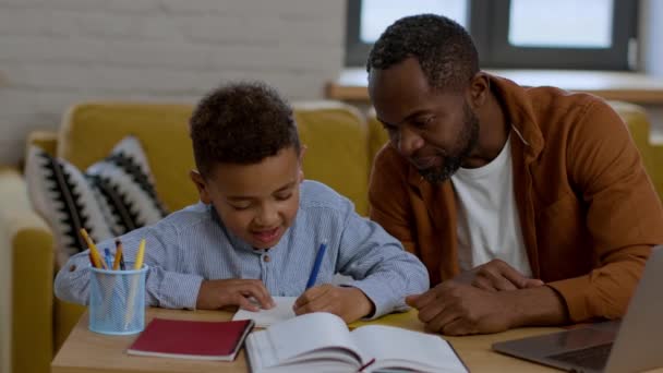 Homeschooling Parent Cute Preteen African American Boy Studying Online Writing — Vídeo de Stock