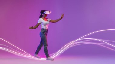 Virtual World. Excited African American Lady Wearing Vr Headset Walking On Glowing Neon Light Lines Over Purple Background, Amazed Black Woman Enjoying Modern Technologies For Entertainment, Panorama