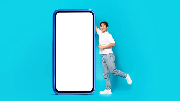 Happy Chinese Teen Guy Pointing Finger Huge Smartphone Blank Screen — 스톡 사진
